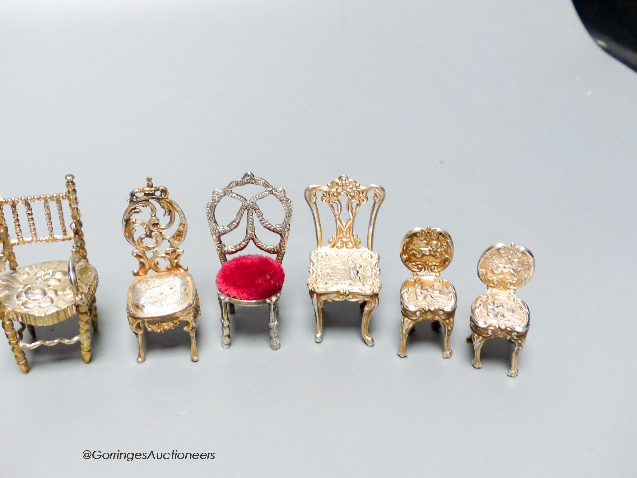 A late Victorian miniature silver model of a chair, 57mm, one other Edwardian chair, two pairs of modern silver chairs and three continental chairs including Dutch.